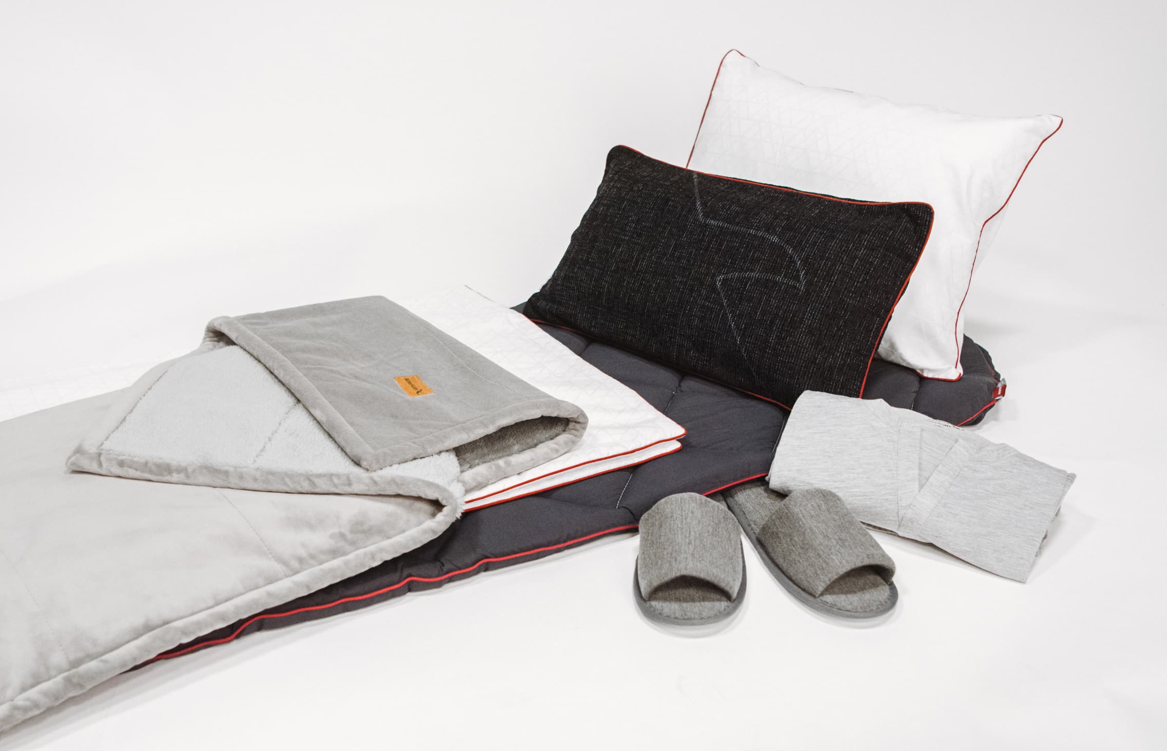 Pillows, sandals and other soft goods on a white background
